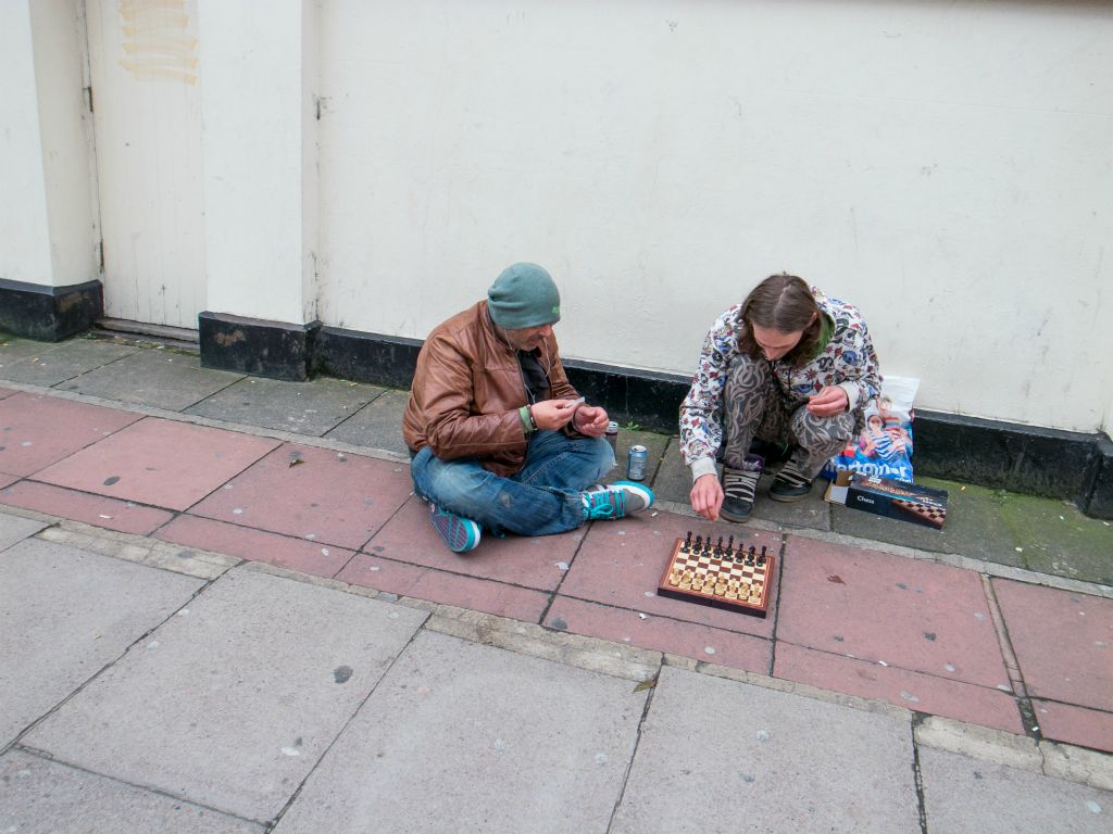 Homeless men play chess on the Street on Queens Road in Brighton.